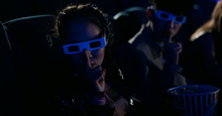 Virtualization - Teenagers in a 3D Glasses in a Cinema and Making Hushing Gesture