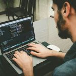 Software - man programming using laptop