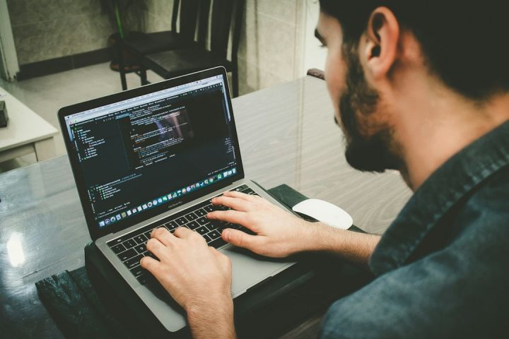 Software - man programming using laptop