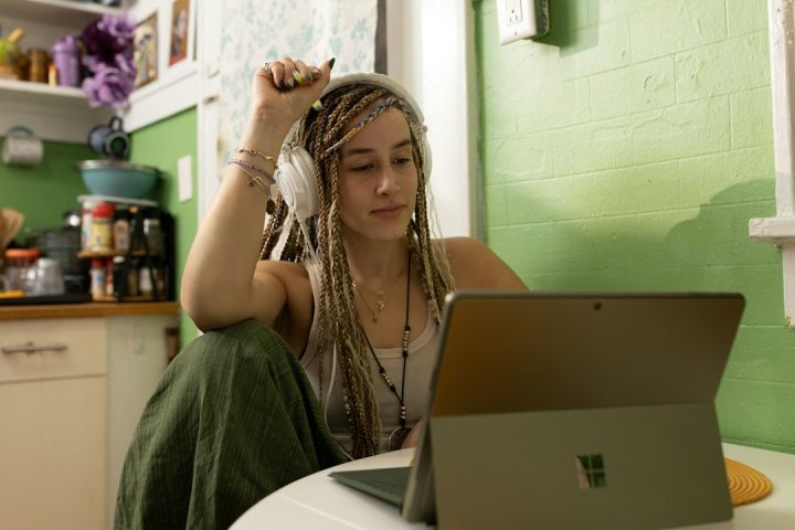 Technology - a woman with dreadlocks sitting in front of a laptop computer
